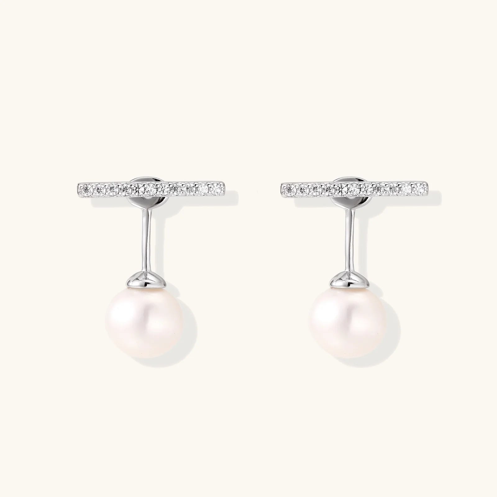 Rhodium-plated sterling silver ear jacket earrings with diamond-set horizontal bar and freshwater pearl drop