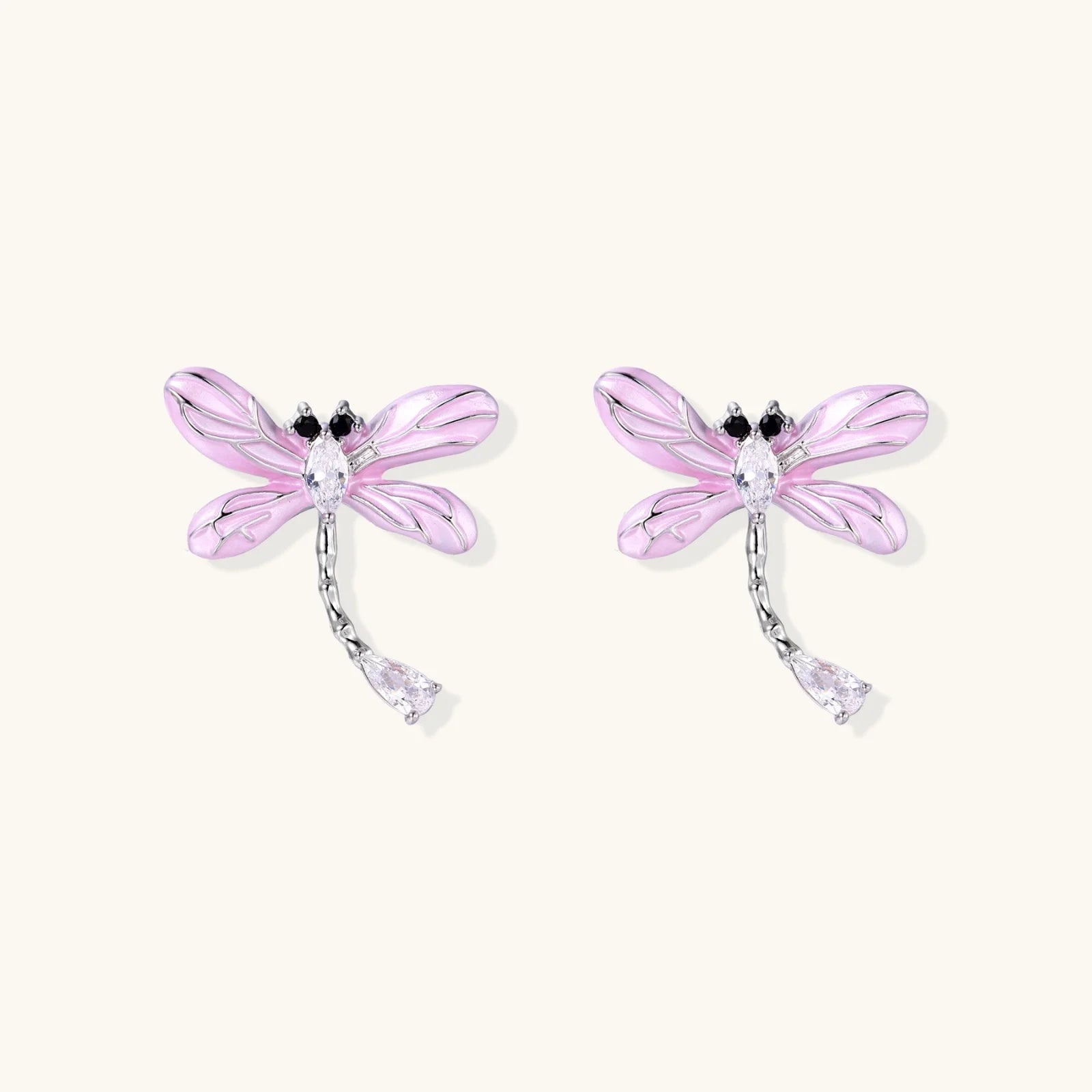 Long drop earrings with translucent lavender enamel dragonfly wings and white gold plated segmented bodies on white background