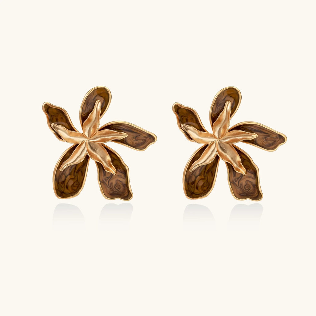 Gold-plated brass flower earrings with brown tortoiseshell enamel petals on cream background