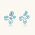 Turquoise enamel flower stud earrings with marbled finish and crystal centers on 18K gold plated brass