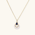 Gold necklace with navy lapis lazuli stone and iridescent mother-of-pearl teardrop pendant with crystal accents