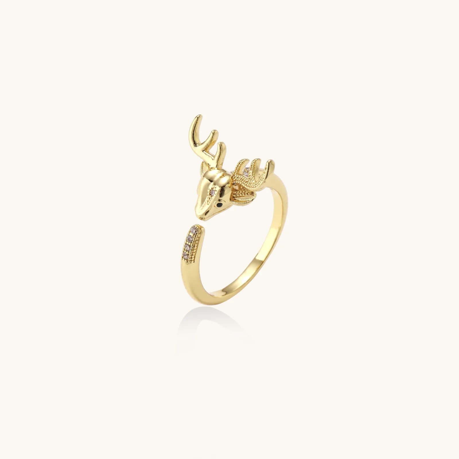 Gold-plated adjustable ring featuring 3D deer head with detailed antlers and cubic zirconia accents on cream background