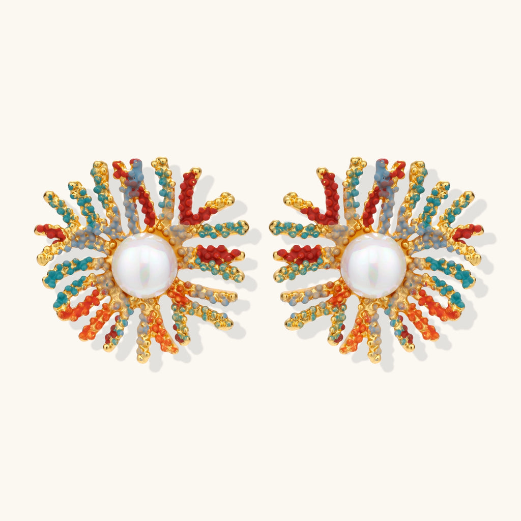 Vibrant starburst stud earrings with multicolor enamel rays and white pearl centers on gold-plated setting