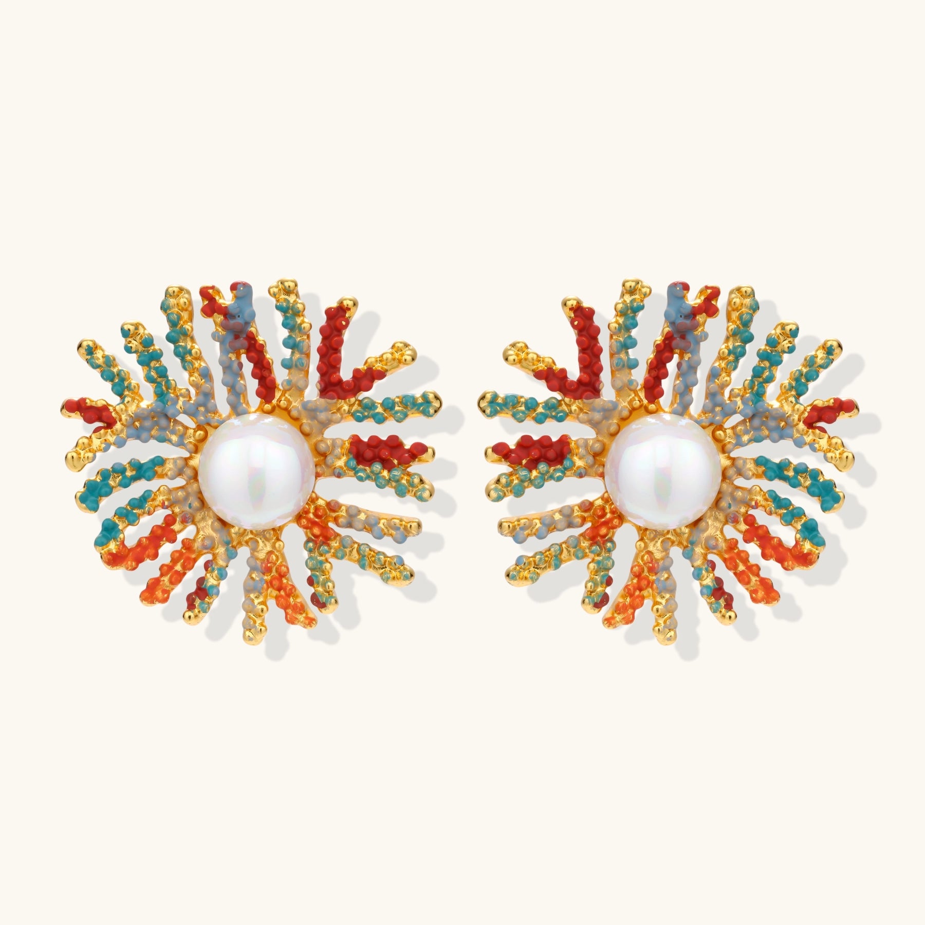 Vibrant starburst stud earrings with multicolor enamel rays and white pearl centers on gold-plated setting