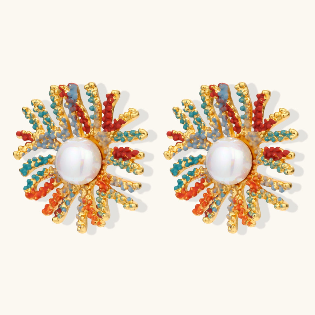 Vibrant starburst stud earrings with multicolor enamel rays and white pearl centers on gold-plated setting